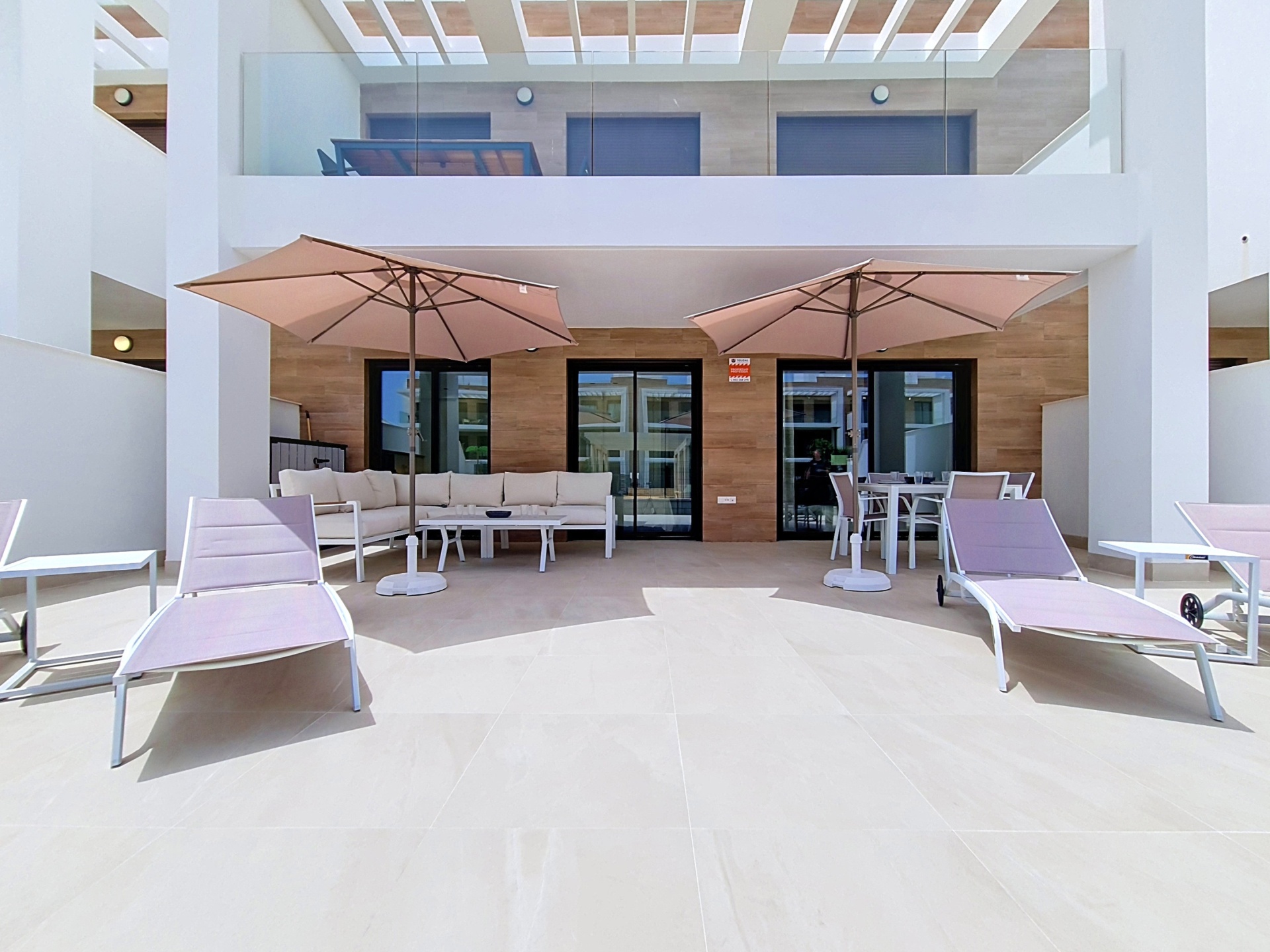 Front-on view of the private terrace with loungers and umbrellas