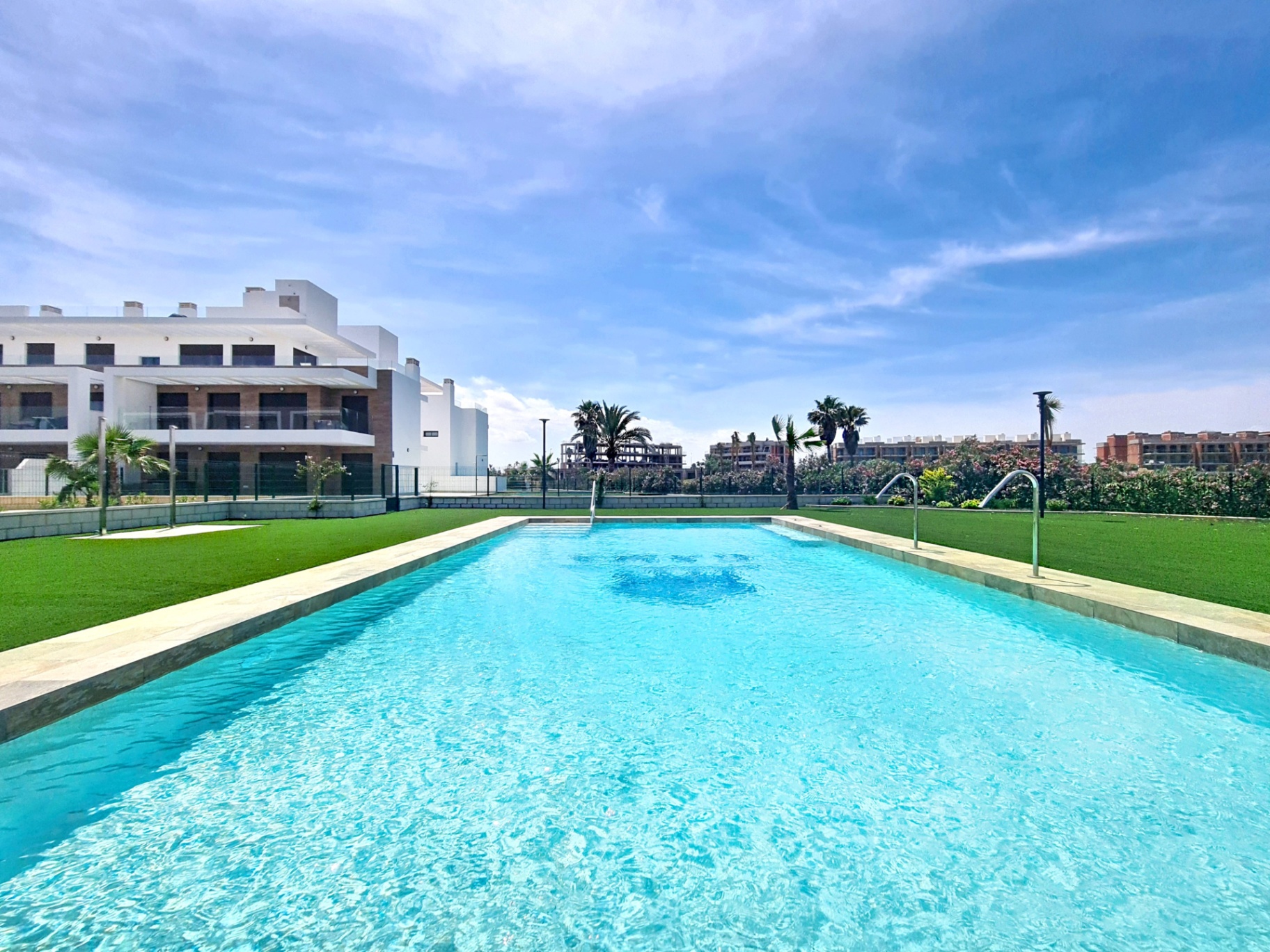 Smaller communal pool under dramatic blue skies