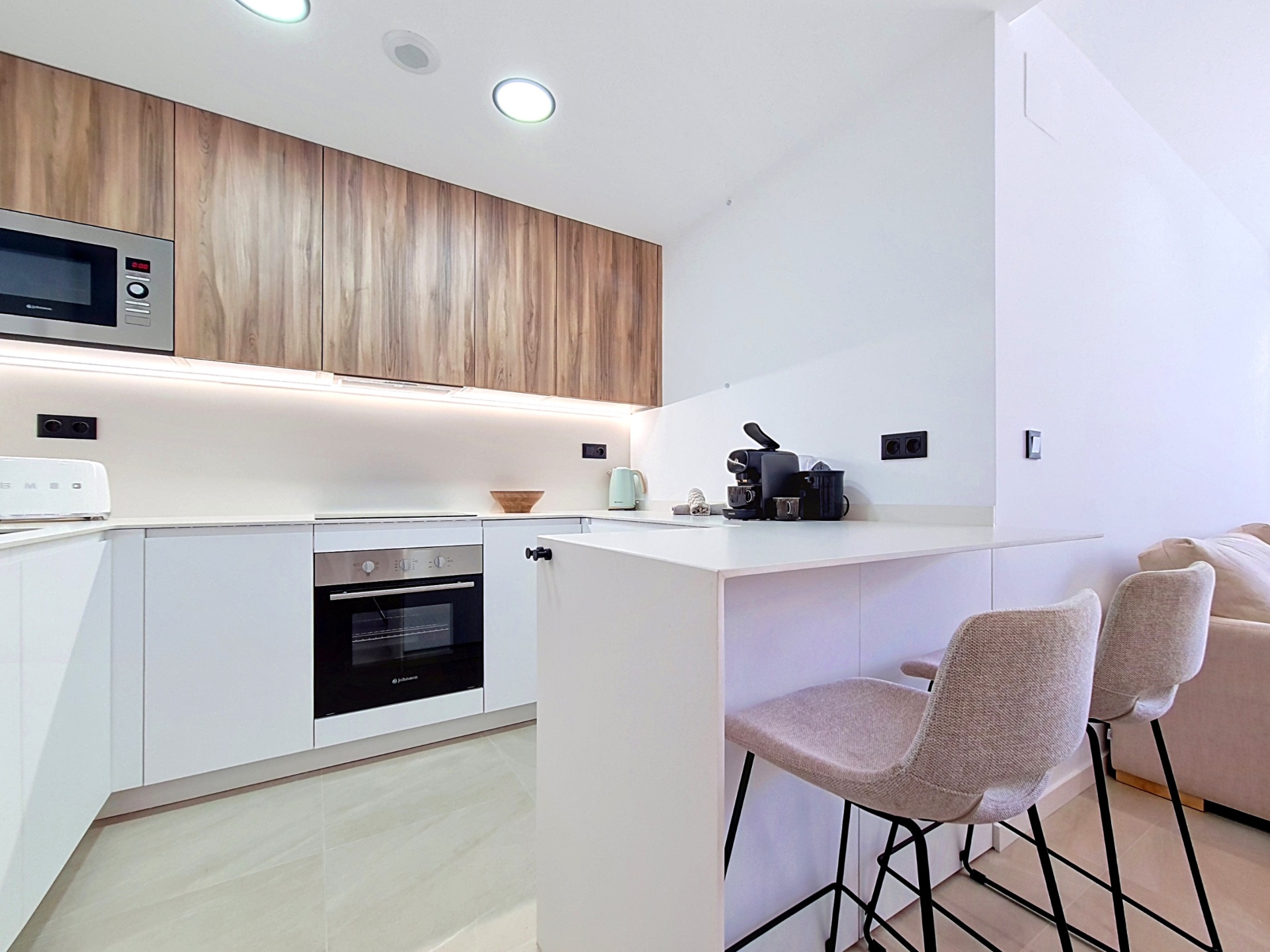 Bright kitchen with breakfast seating and integrated appliances
