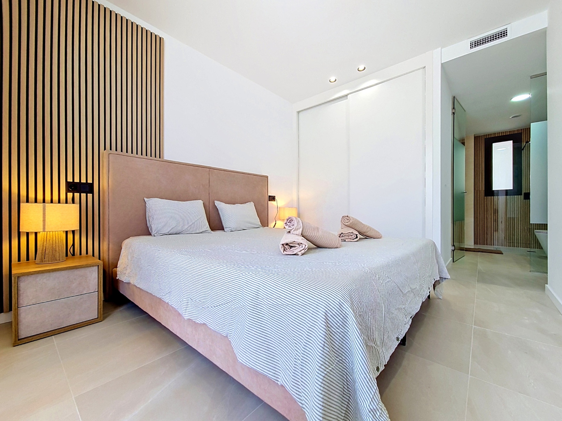 Main bedroom with en-suite bathroom visible beyond