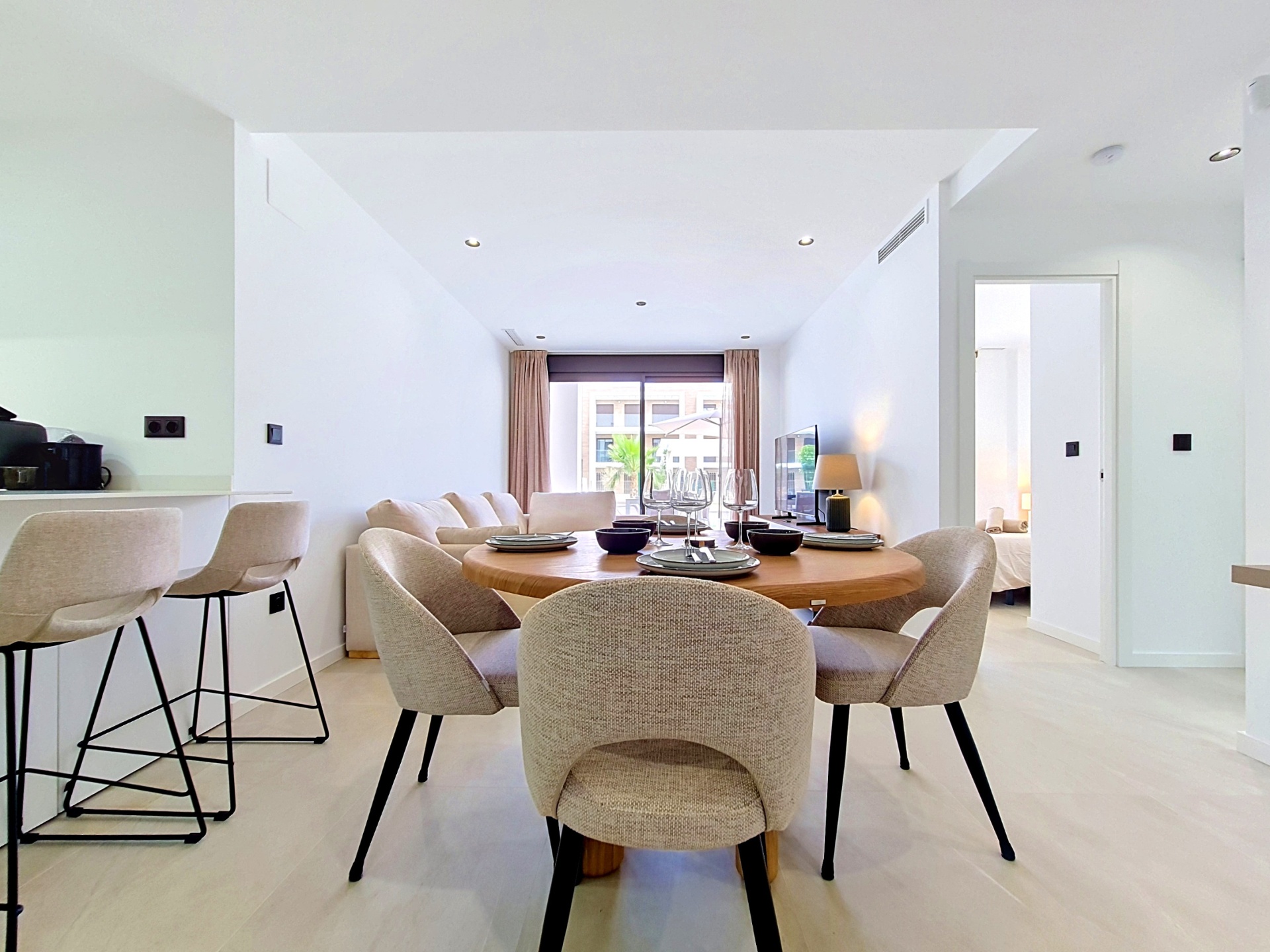 Dining table and living space with terrace beyond