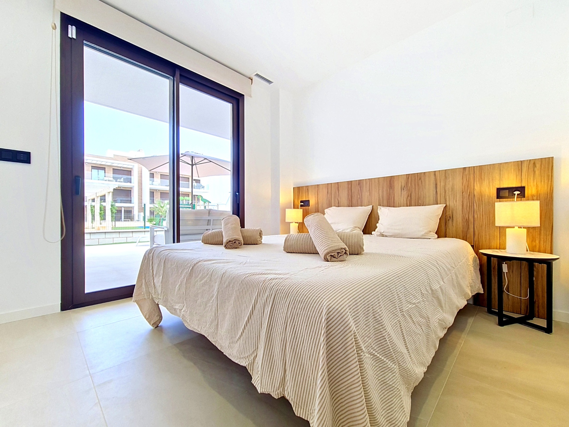 Bedroom with twin setup and warm bedside lighting